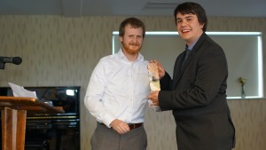Richard receiving his award from Dr Kyle Erickson, Assistant Dean of the Faculty